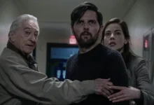 Robert De Niro, Adam Scott e Michelle Monaghan em cena do suspense O Homem que Sussurra (2026), caminhando por um corredor enquanto reagem assustados a uma ameaça fora de quadro