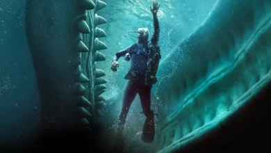 Austin Abrams em cena subaquática do filme Dentro da Baleia (2026), cercado por estruturas semelhantes aos dentes de uma baleia.