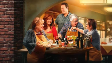 Imagem promocional do filme Nonnas (2025), com Susan Sarandon, Vince Vaughn, Lorraine Bracco, Talia Shire e Brenda Vaccaro reunidos em uma cozinha aconchegante, sorrindo e preparando comida juntos em clima descontraído