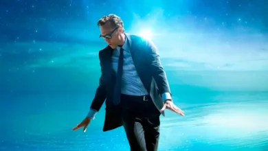 Tom Hiddleston em cena promocional do filme A Vida de Chuck, com fundo celestial e visual fantástico