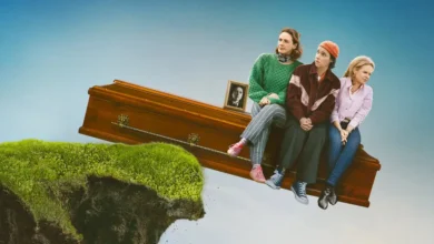 Trio de protagonistas interpretadas por Sinéad Keenan, Roisin Gallagher e Caoilfhionn Dunne sentadas sobre um caixão prestes a cair de um penhasco em De Belfast ao Paraíso (2026).