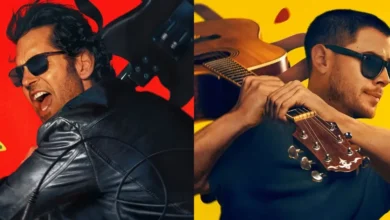 Paul Rudd e Nick Jonas em imagem promocional do filme Hit Para Dois (2026), usando óculos escuros e segurando guitarras em fundo vermelho e amarelo.