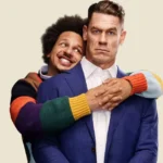 John Cena e Eric André em imagem promocional de Little Brother (2026), com Eric André abraçando John Cena por trás em cena de tom cômico.