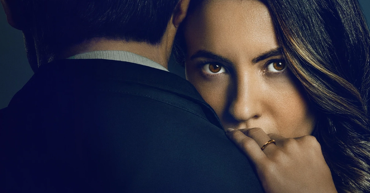 Imagem promocional do filme "O Jogo da Viúva" (2025), da Netflix, com Ivana Baquero encarando a câmera enquanto abraça o personagem de Tristán Ulloa.