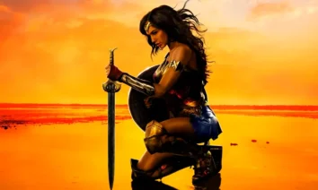 Gal Gadot como Mulher-Maravilha ajoelhada ao pôr do sol segurando uma espada — imagem relacionada às curiosidades de Mulher-Maravilha