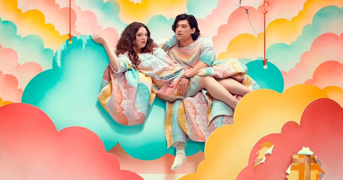 Imagem promocional da série Too Much (2025) da Netflix, estrelando Megan Stalter e Will Sharpe, com cenário colorido de nuvens e céu de festa.