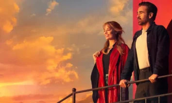 Cena do filme A Grande Viagem Da Sua Vida com Margot Robbie e Colin Farrell no pôr do sol, destaque do novo trailer de A Grande Viagem Da Sua Vida.
