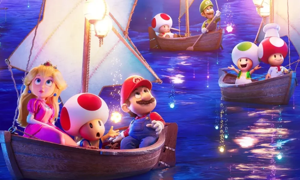 super mario galaxy o filme trailer Cena colorida do trailer de Super Mario Galaxy, mostrando Mario, Princesa Peach e Toads navegando em barcos iluminados sob um céu estrelado no novo filme da Universal Pictures, com estreia em 3 de abril de 2026.