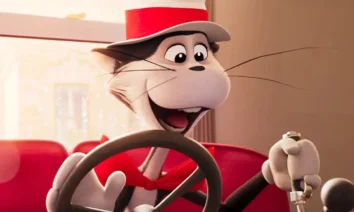 Cena do filme animado O Gatola da Cartola (2026), mostrando o carismático gato dirigindo um carro vermelho e sorrindo entusiasmado.