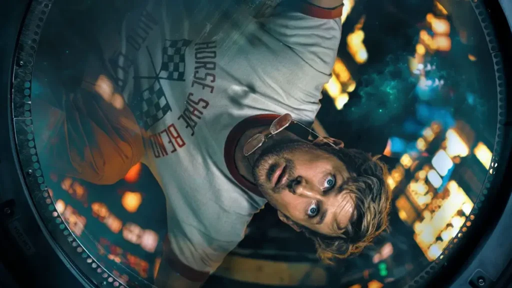 Ryan Gosling em ângulo dramático olhando através de escotilha circular em Devoradores de Estrelas, ficção científica que é uma das estreias de 2026