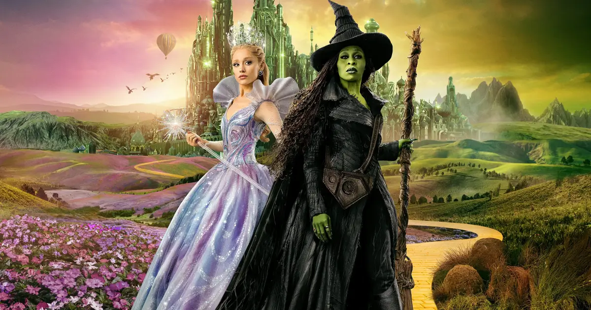 Cynthia Erivo e Ariana Grande em Wicked Parte 2, principal destaque das estreias de 20 de novembro de 2025, posando na estrada de tijolos amarelos com a Cidade Esmeralda ao fundo