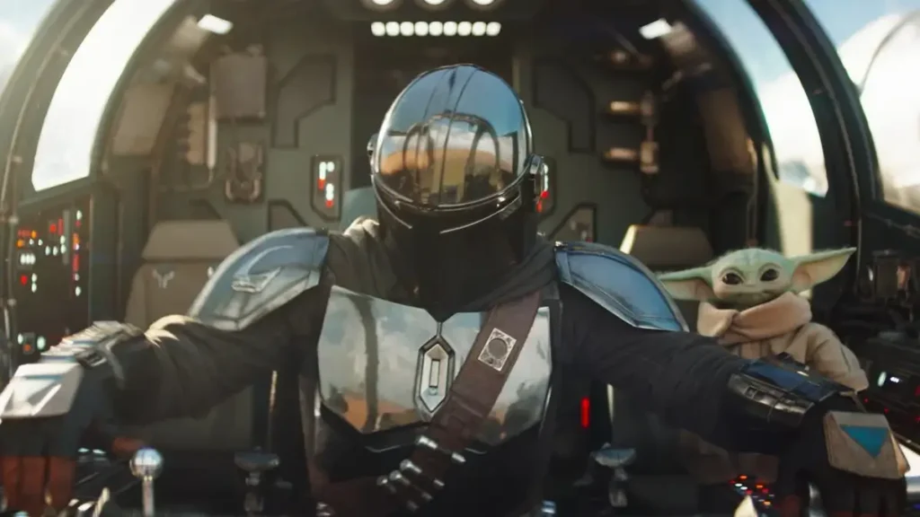 Mandaloriano pilotando nave com Grogu (Baby Yoda) ao lado em O Mandaloriano e Grogu, filme Star Wars nos filmes 2026