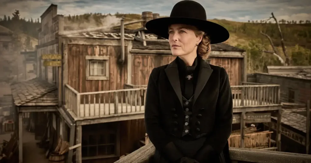 os abandonados gillian anderson Gillian Anderson como Constance Van Ness em Os Abandonados (The Abandons) da Netflix, vestindo traje preto de época vitoriana e chapéu de aba larga, em cenário de cidade do velho oeste