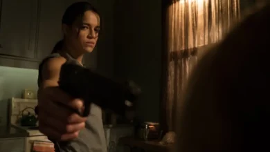 Michelle Rodriguez aponta uma arma em cena tensa do filme Vingança (2016), em ambiente escuro e com clima de suspense.