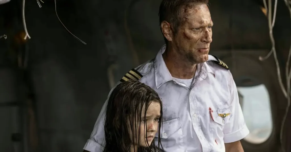Aaron Eckhart e Molly Belle Wright em cena do elenco de Águas Mortais (2026) durante um momento de tensão a bordo de um avião após um acidente.