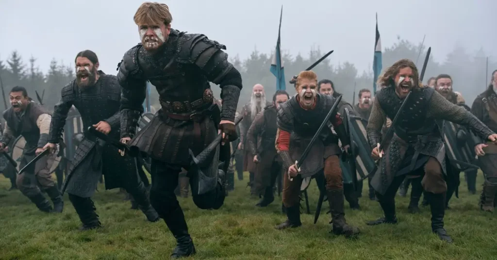 Elenco de Bloodaxe (2027), com Xavier Molyneux e outros atores caracterizados como guerreiros vikings em uma cena de batalha.