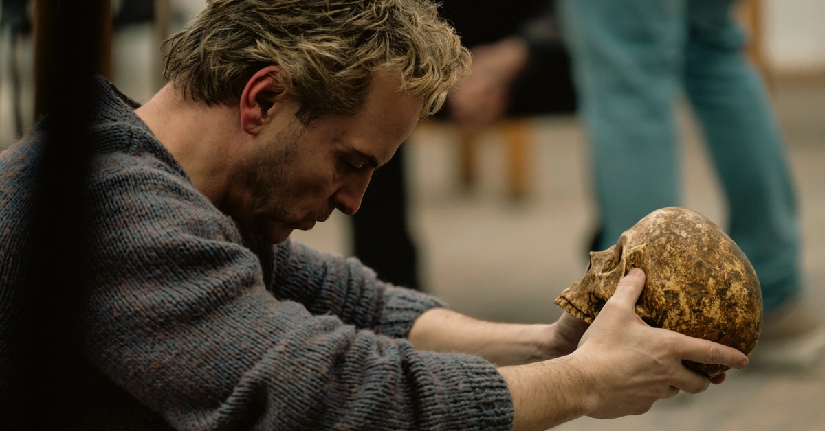 Andrew Scott em Elsinore, drama biográfico em que interpreta o ator Ian Charleson, segurando uma caveira durante a preparação para a peça Hamlet.
